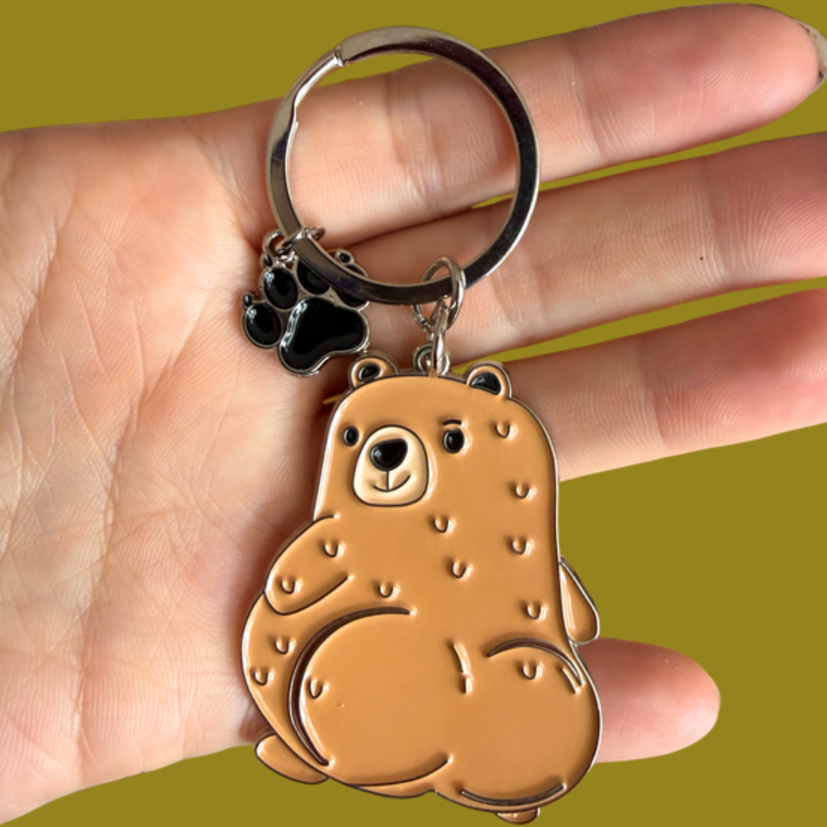 Cuddly Bear keychain held in hand