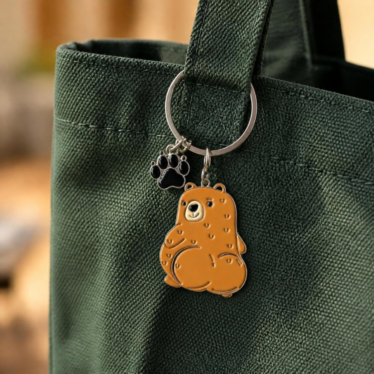 Cuddly Bear keychain hanging from a green tote bag