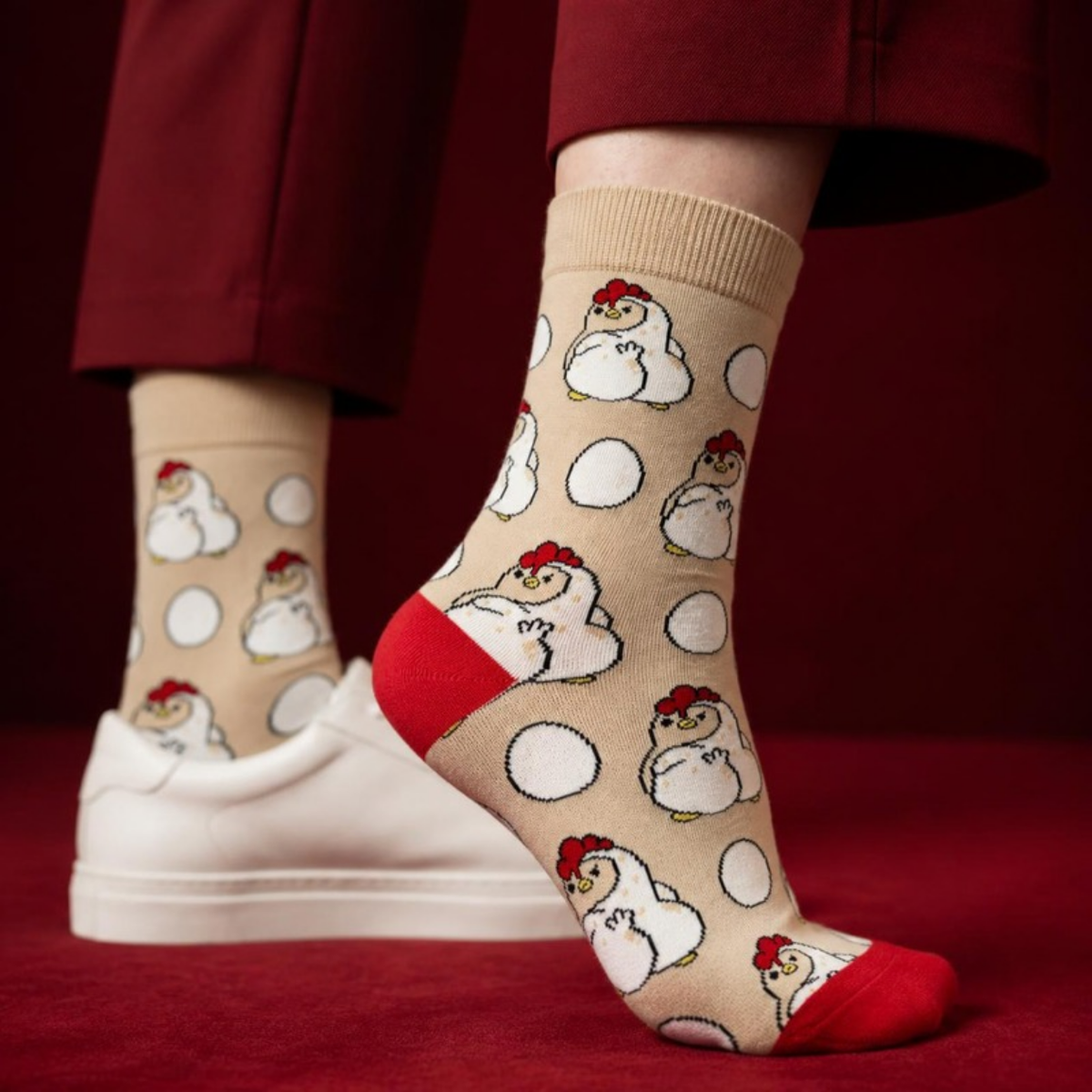 Sassy Chicken Socks worn with sneakers against a red backdrop